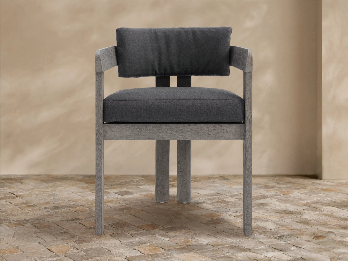 Textured light gray Milos Outdoor Collection Cover on furniture with a front vertical seam, on a stone patio.