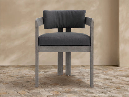 Textured light gray Milos Outdoor Collection Cover on furniture with a front vertical seam, on a stone patio.