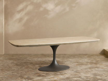 Outdoor Dining Table with light sintered stone top, dark grey conical Launette base, on a patterned tiled patio.