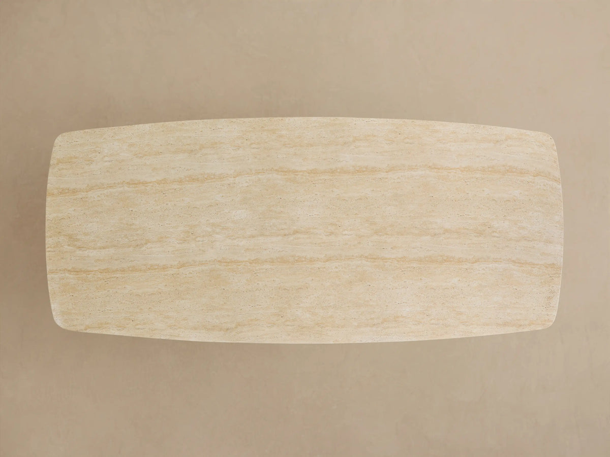 Close-up of an Outdoor Dining Table with a natural light beige, textured sintered stone top and a dark gray Launette base.