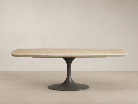 Outdoor Dining Table with light sintered stone top, dark grey conical Launette base, on a patterned tiled patio.