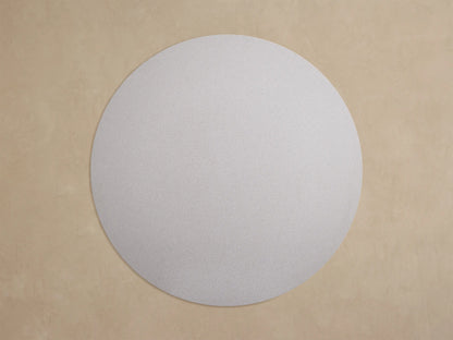 Close-up of a light gray speckled round Outdoor Dining Table, showing its thick edge and a dark gray angular Apex base leg.