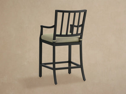 Close-up of Montego Outdoor Aluminum Counter Stool, showing its black aluminum frame with slatted back and textured Eden Sage cushion.