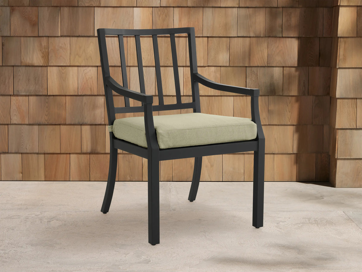 Montego Outdoor Aluminum Dining Arm Chair with dark gray frame, slatted back, armrests, and light sage cushion.
