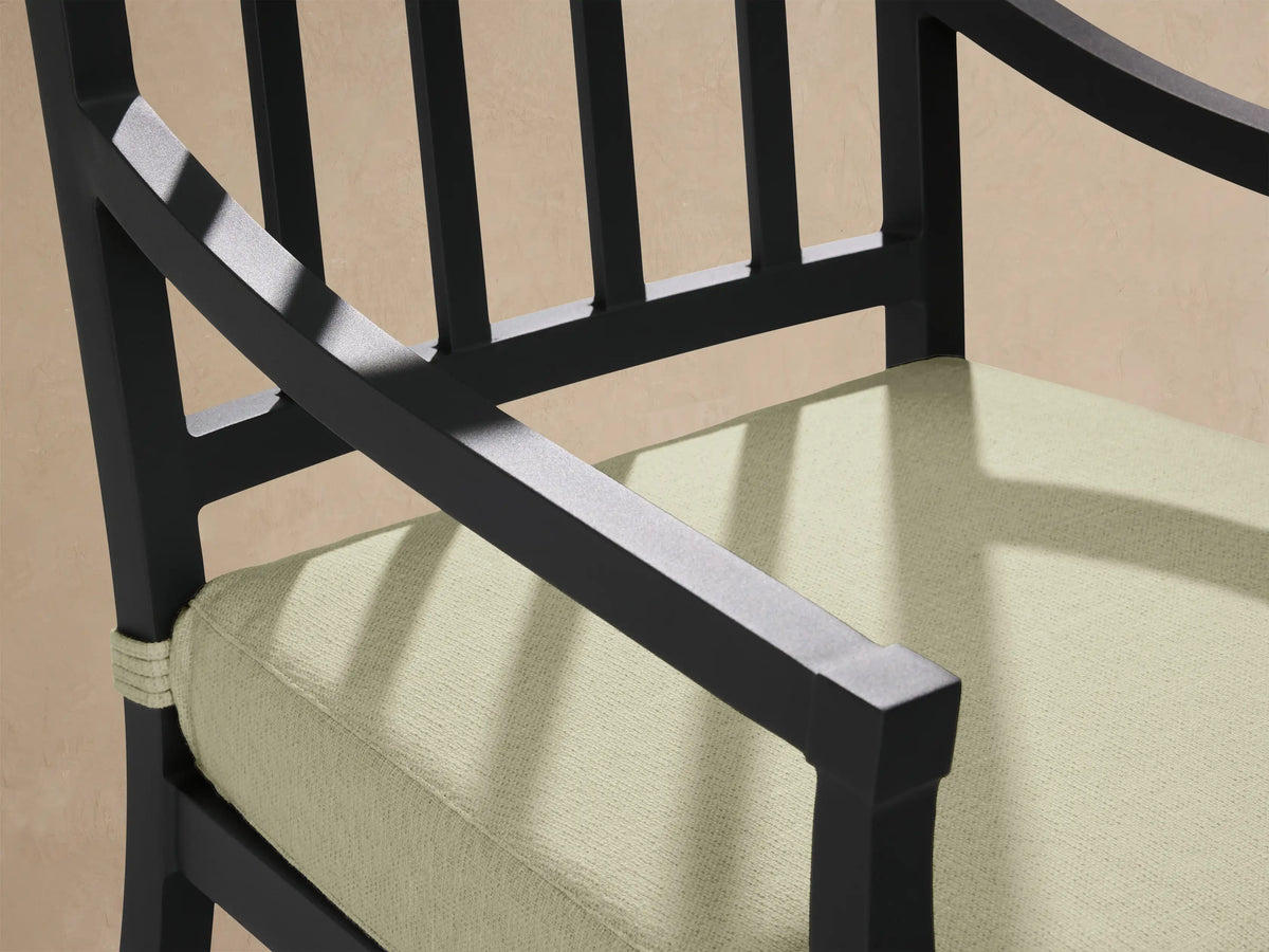 Montego Outdoor Aluminum Dining Arm Chair with a dark gray frame, slatted back, and light green Eden Sage seat cushion. Full view.