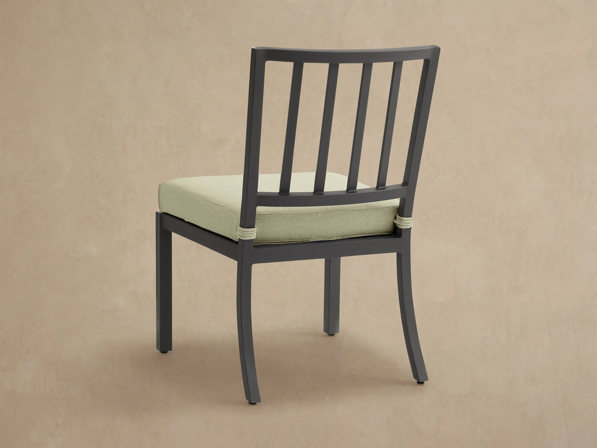 Close-up of Montego Outdoor Aluminum Dining Side Chair. Black aluminum frame, Eden Sage seat cushion with shadows.