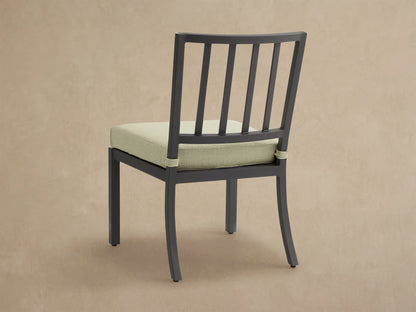 Close-up of Montego Outdoor Aluminum Dining Side Chair. Black aluminum frame, Eden Sage seat cushion with shadows.