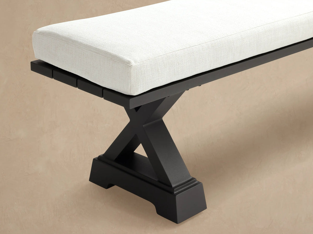 Montego Outdoor Aluminum Dining Bench with white cushion and dark gray X-shaped aluminum legs, shown front-facing.