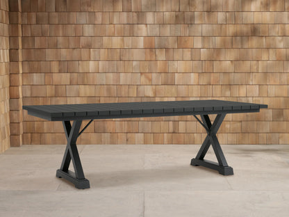 Dark gray Montego Outdoor Aluminum Dining Table with rectangular slatted top and A-frame legs, on a light patio.