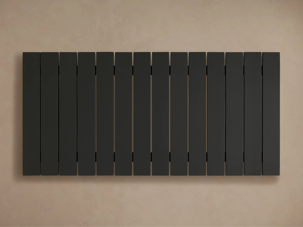 Close-up of black Montego Outdoor Aluminum Coffee Table, showing its slatted top and thick, angled leg on a light background.