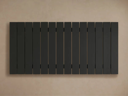 Close-up of black Montego Outdoor Aluminum Coffee Table, showing its slatted top and thick, angled leg on a light background.