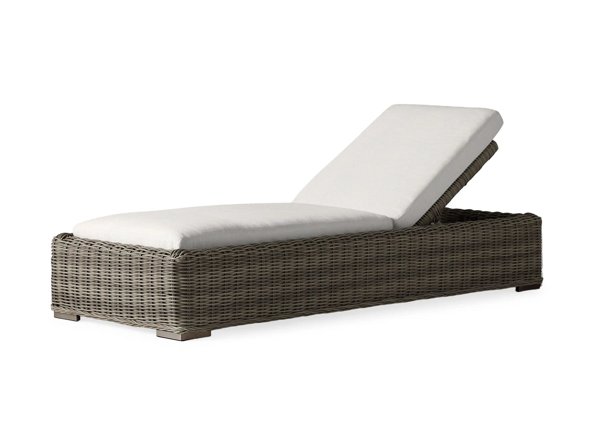 Front view of the Dry Bark Montauk Outdoor Chaise with cream cushions, featuring handwoven resin wicker and an adjustable back.