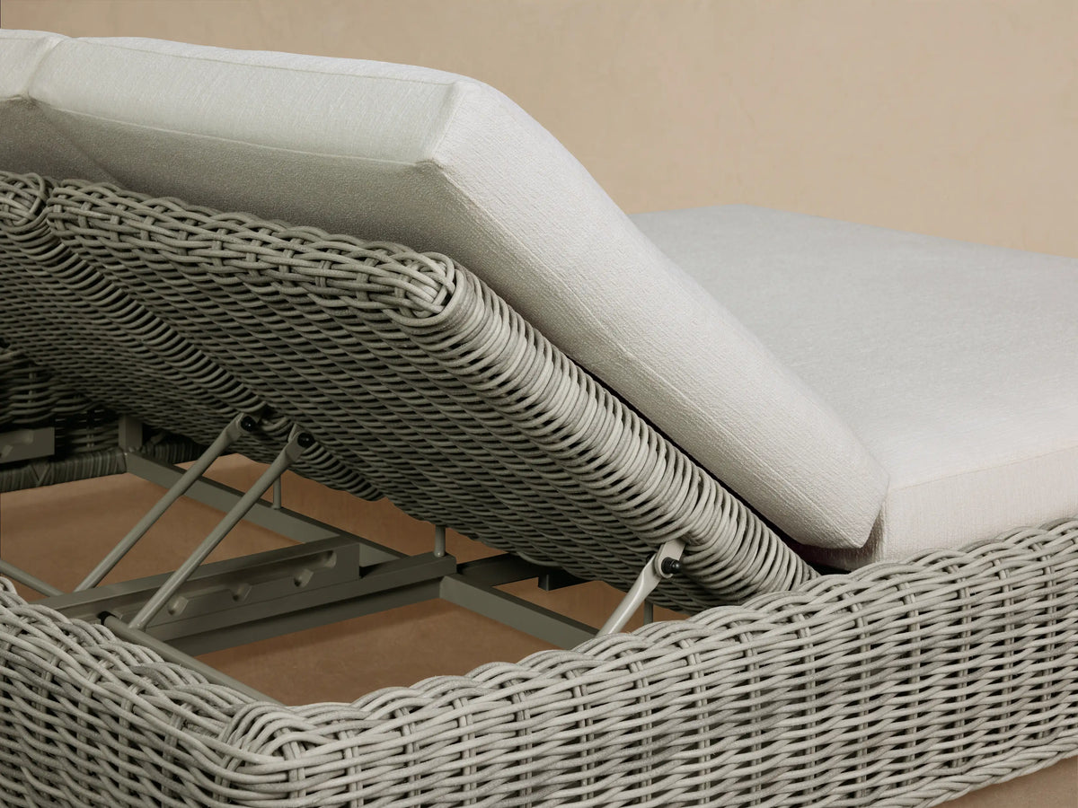 Detail of the adjustable backrest on the light grey handwoven all-weather resin wicker Montauk Outdoor Double Chaise.