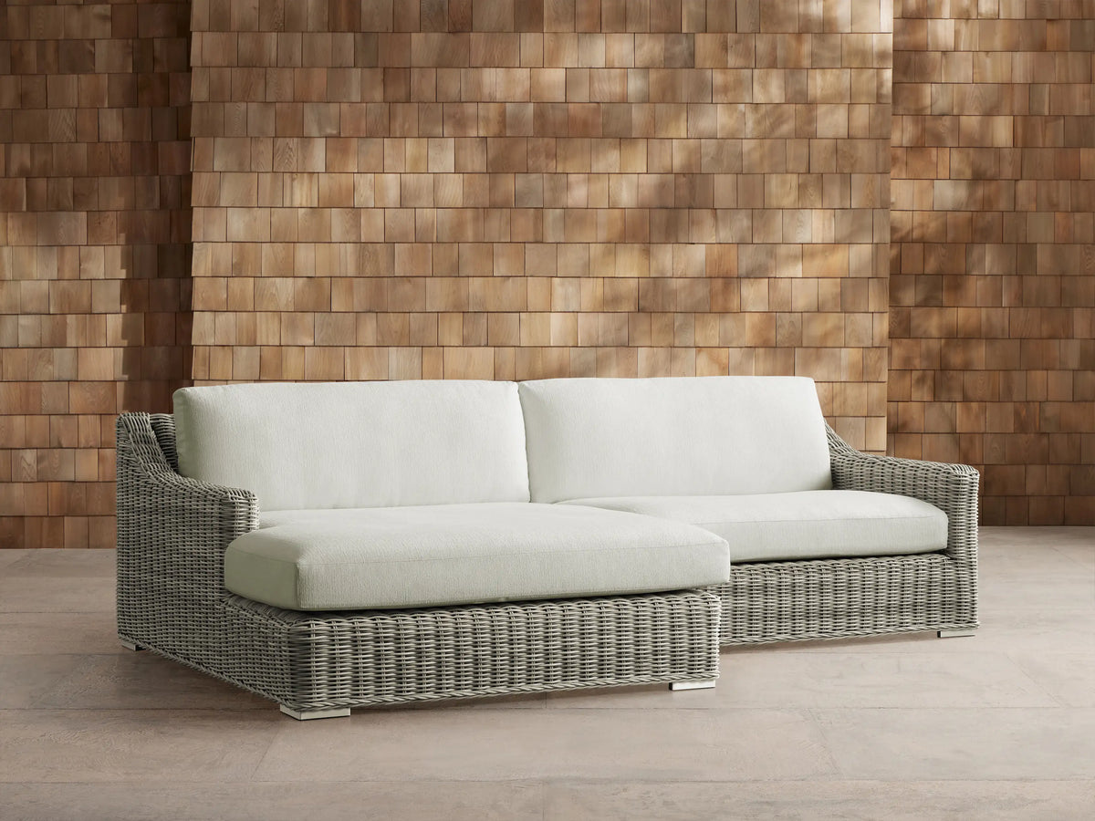 Front view of a light gray woven resin wicker Montauk Outdoor Two-Piece Sectional with pale sage cushions.