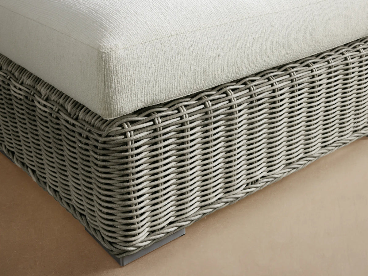 Montauk Outdoor Ottoman: light sage all-weather woven resin wicker base with a cream cushion and stainless steel feet.