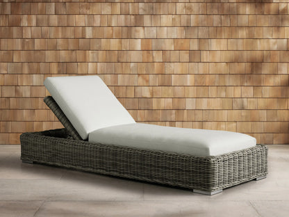 Front view of the Montauk Outdoor Chaise with gray-green woven resin wicker and light cream cushions.