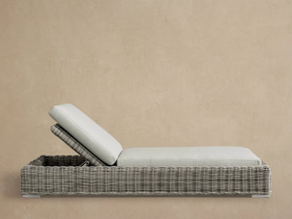 Front view of the Montauk Outdoor Chaise with gray-green woven resin wicker and light cream cushions.