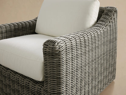 Front view of the Vista Grey Montauk Outdoor Swivel Chair, featuring handwoven resin wicker and light-colored seat and back cushions.