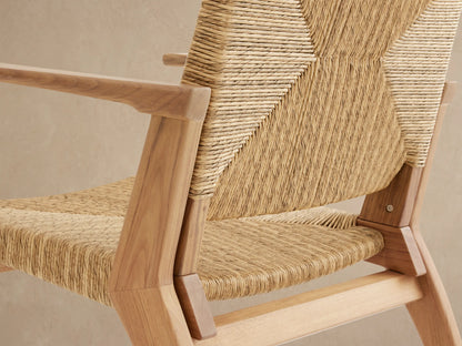 Mustique Outdoor Dining Arm Chair. Light natural teak frame, woven wicker seat & back with central square pattern, front view.
