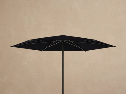Underside view of a Nata Outdoor Round Umbrella. Black canopy and dark gray aluminum frame ribs converge at the center.