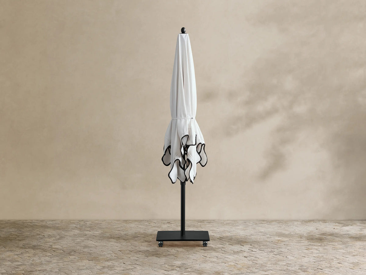 Underside view of Nata Outdoor Square Scalloped Umbrella. White canopy, black ribs & pole. Scalloped beige edge with black trim.
