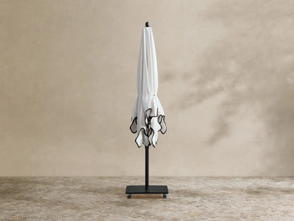 Underside view of Nata Outdoor Square Scalloped Umbrella. White canopy, black ribs & pole. Scalloped beige edge with black trim.