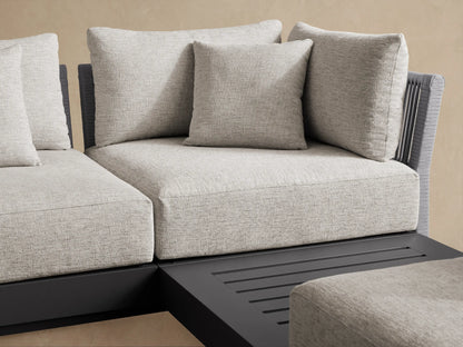 Naxos Outdoor Seven-Piece Sectional, L-shaped, with light grey cushions & dark grey frame, including a slatted chaise on patio.