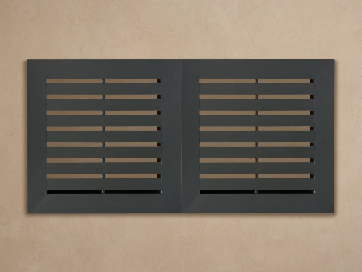 Close-up of Naxos Outdoor Double Coffee Table corner, showing dark gray slatted surface with powder-coated aluminum frame.