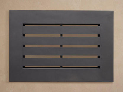 Close-up of Naxos Outdoor End Table. Smooth charcoal gray slatted top with an angular frame, viewed from the top corner.