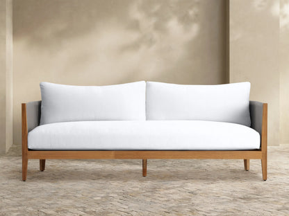 Front view of a two-seater outdoor sofa with plush white Newport Water-Repellent Replacement Cushions on a tiled patio.