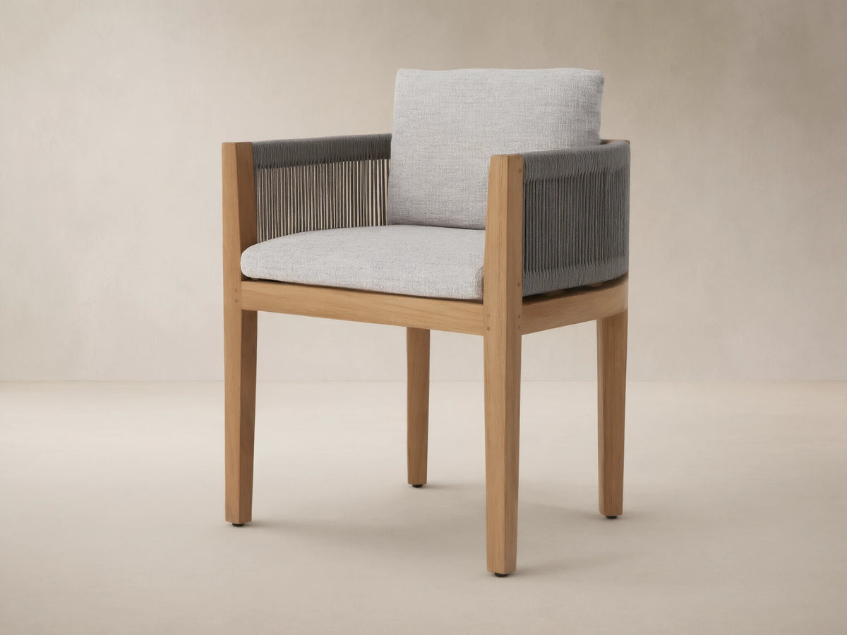Newport Outdoor Dining Arm Chair, Shardai Zinc, with natural teak frame, dark grey woven rope arms, and light grey seat & back cushions.