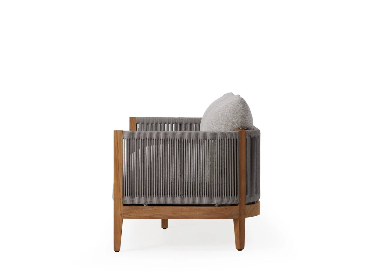 Newport Outdoor Sofa with teak frame, light gray cushions, and woven sides. Sleek, modern design, suitable for outdoor use.
