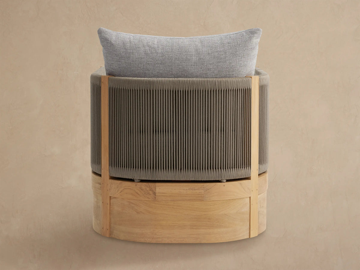 Close-up, angled view of Newport Outdoor Lounge Chair. Teak wood frame with taupe woven rope sides & light grey cushions.