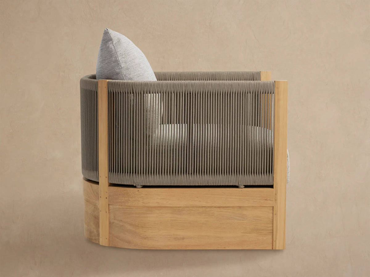 Newport Outdoor Lounge Chair, front view. Rounded chair with grey woven rope upper, natural teak base, and light grey cushion.
