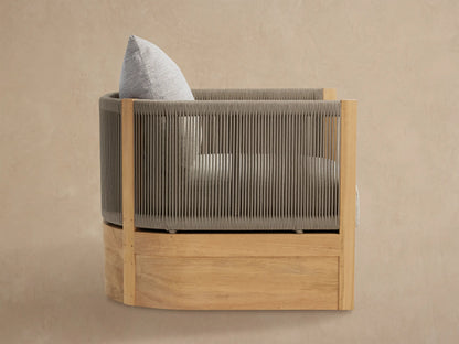 Newport Outdoor Lounge Chair, front view. Rounded chair with grey woven rope upper, natural teak base, and light grey cushion.