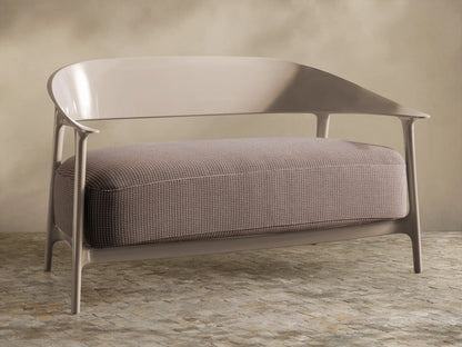 Nia Outdoor Sofa: Modern light greige frame, curved back, arms. Single large textured beige cushion, front view.