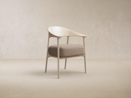 Nia Outdoor Dining Chair, light beige molded frame and speckled brown cushion, angled right on a stone tiled floor.