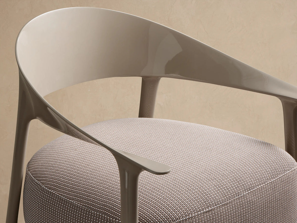 Nia Outdoor Lounge Chair: Light taupe curved frame, arms & legs with a thick, textured brown & cream cushion, facing forward.