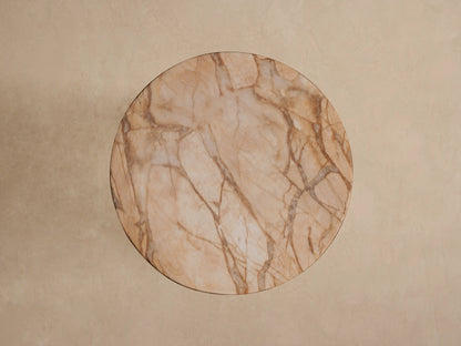 Close-up of Odessa Outdoor End Table, round light brown top & thick support with dark brown stone-like veining.