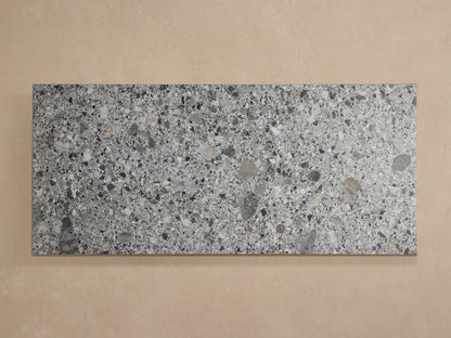 Paloma Outdoor Coffee Table with a speckled grey, black, and white sintered stone top and matte black aluminum frame.