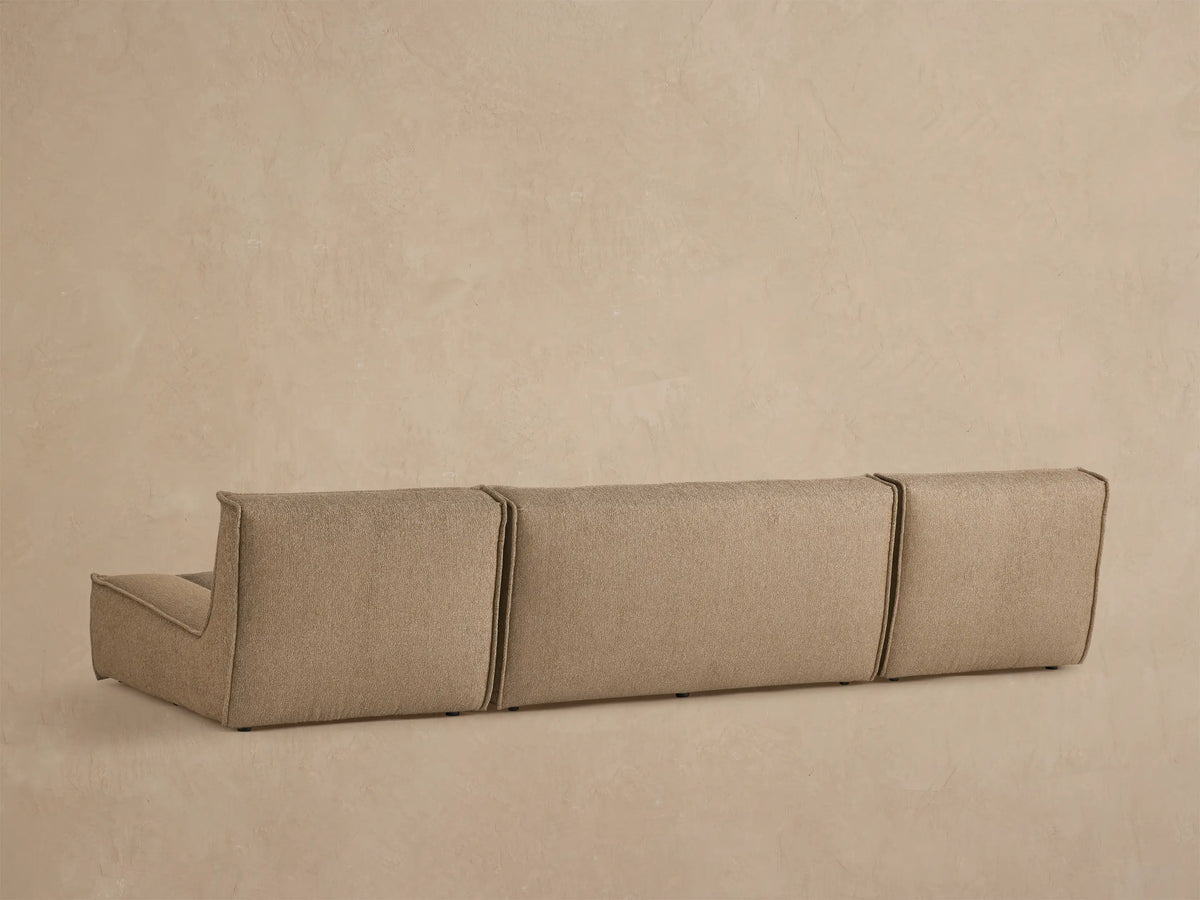 Close up of Porto three piece double chaise sectional in dark beige fabric with channel stitching