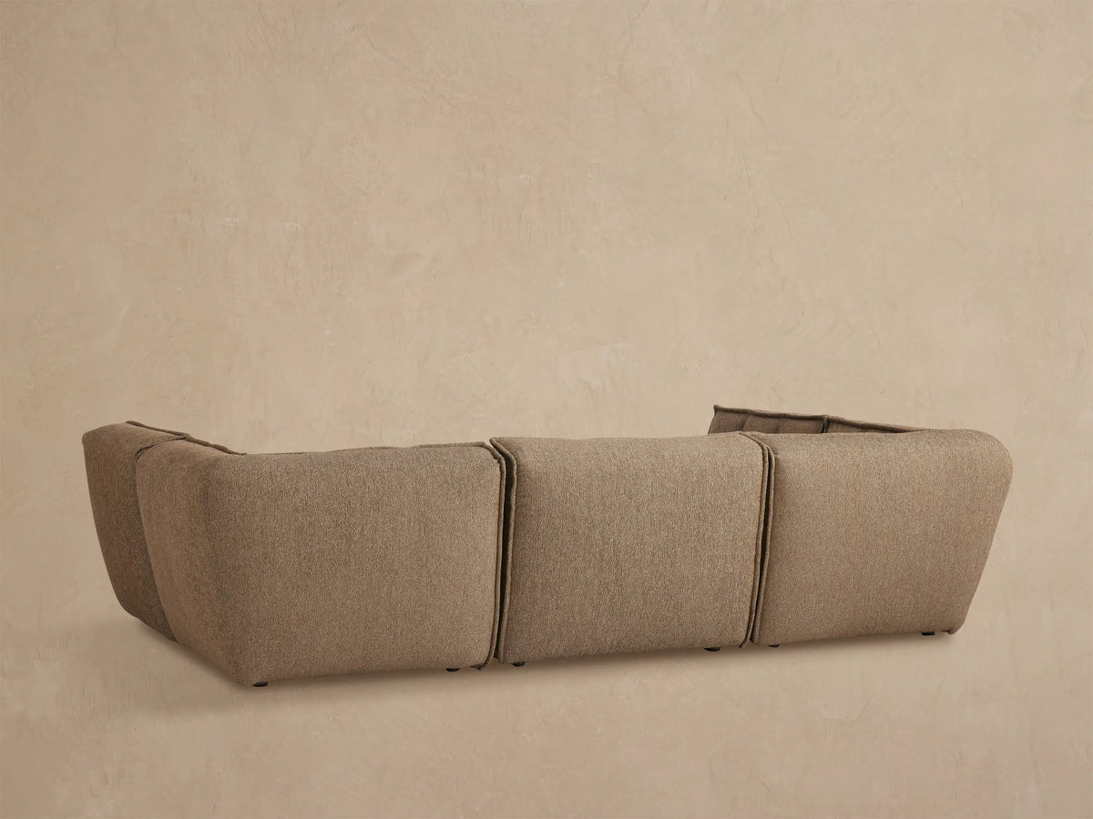 Close up of Porto six piece pit sectional in dark beige fabric with channel stitching