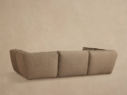 Close up of Porto six piece pit sectional in dark beige fabric with channel stitching