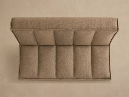 Back view of Porto armless sofa in dark beige fabric with channel stitching