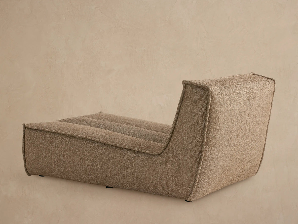 Close up of Porto armless chaise in dark beige fabric with channel stitching
