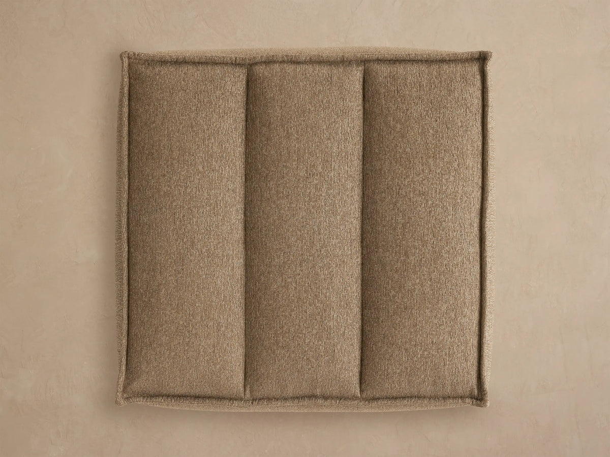 Porto ottoman in dark beige fabric with channel stitching
