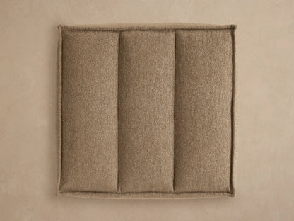 Porto ottoman in dark beige fabric with channel stitching
