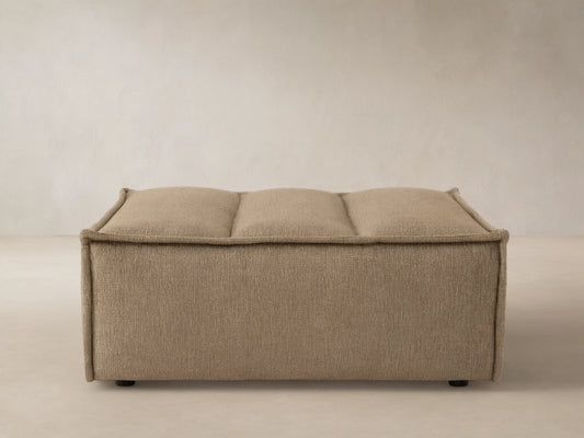 Porto ottoman in dark beige fabric with channel stitching