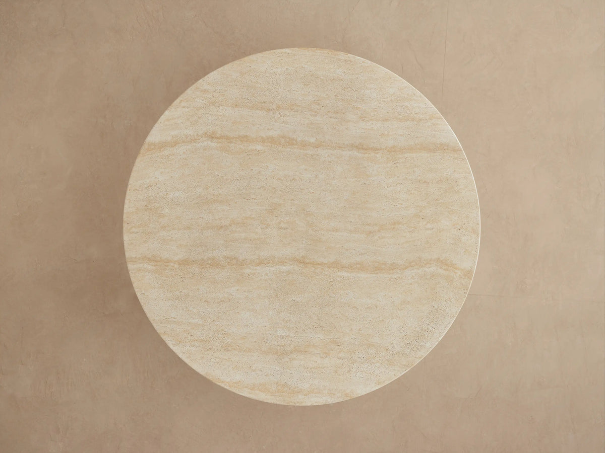 Close-up of Primrose Outdoor Round Dining Table, showing beige stone-like texture of the tabletop edge and sculptural pedestal base.