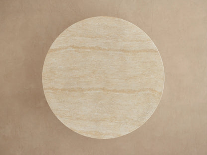 Close-up of Primrose Outdoor Round Dining Table, showing beige stone-like texture of the tabletop edge and sculptural pedestal base.